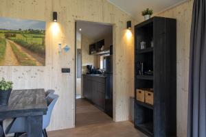 a kitchen with wooden walls and a table and a counter at Nieuw!! Chalet De Luxe 4 persoons met airco in Oorsbeek