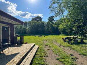 a yard with a wooden deck and a picnic table at Salatse metsa mesionn in Salatse
