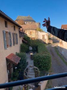 a person standing on a balcony looking at an alley at ROMELLA's ROOM FAMILY in Saint-Projet +1 photo
