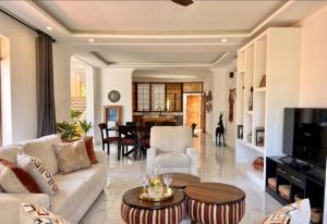 a living room with a couch and a table at Casa Samara in Diani Beach