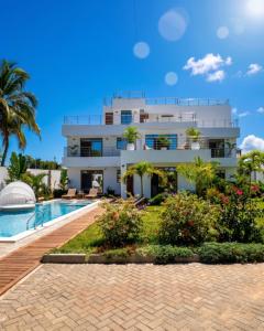 a villa with a swimming pool and a resort at Casa Samara in Diani Beach