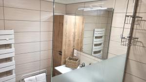 a bathroom with a sink and a mirror at AGENCE MOMENT'APART Legend in Mouvaux +8 photos