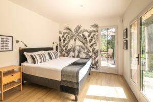 a bedroom with a bed and a large window at Villa la Rabassa in Lauris +20 photos