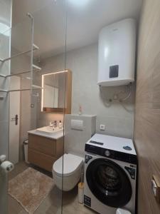 a bathroom with a washing machine and a toilet at Apartmani ANCORA, Crkvice in Kuna Pelješka +44 photos