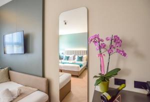 a mirror in a living room with a bedroom at CP Hotels - Central in Milan