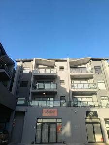 an apartment building with balconies on the side of it at Millennial Arch in Langebaan