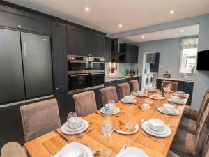 a dining room with a wooden table and chairs at Ruby's Retreat in Filey