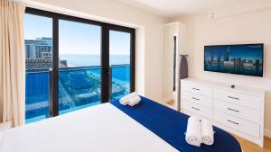 a bedroom with a large bed and a large window at The Infinity Panorama Batumi in Batumi +60 photos