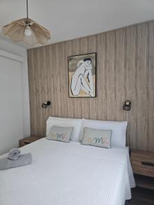 a bedroom with a white bed with two pillows at Apartamento relax Tauro in Mogán +17 photos