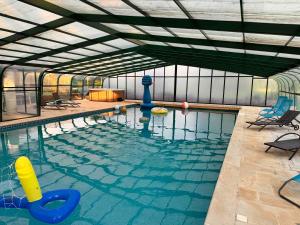 a large swimming pool with a pool at Clos de Joco - Gîte de groupe in Pas-de-Jeu