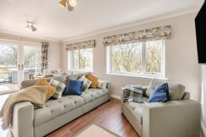 a living room with two couches and two windows at 2 Bed in Ochiltree oc-w37516 in Ochiltree