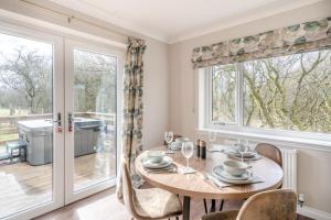 a dining room with a table and a large window at 2 Bed in Ochiltree oc-w37516 in Ochiltree