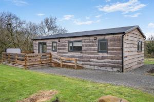 a log cabin with a wooden fence and grass at 2 Bed in Ochiltree oc-w37516 in Ochiltree