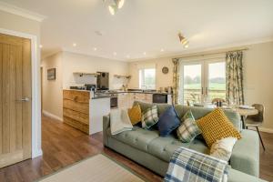 a living room with a couch and a kitchen at 2 Bed in Ochiltree oc-w37517 in Ochiltree