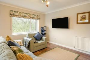 a living room with a couch and a tv at 2 Bed in Ochiltree oc-w37517 in Ochiltree