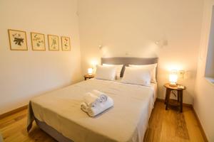 a bedroom with a bed with towels on it at Thalassa Seaside Apartments in Sikéa +60 photos