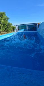 a person in a pool of blue water at Olive Grove Retreat Podgorica in Vranj