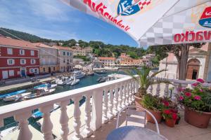a balcony with a view of a canal with boats at Bed&Breakfast Saturn in Veli Lošinj