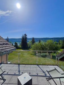 a patio with a view of a field at Lake View Balcony in Le Chenit