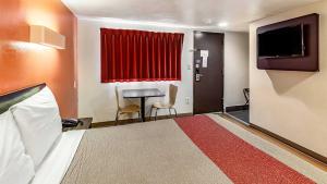 a hotel room with a bed and a table and a window at Hotel Elizabeth Near Newark Liberty International Airport New Jersey in Elizabeth +14 photos