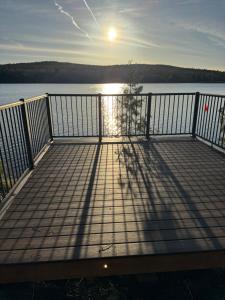 a boardwalk with the sun shining on the water at Oak Glade RV site in Westfield Beach