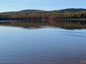 a large body of water with trees in the background at Oak Glade RV site in Westfield Beach