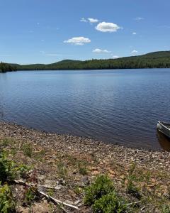 a view of a lake with a boat on the shore at Oak Glade RV site in Westfield Beach