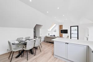 a dining room and living room with a table and chairs at Corn Flour Lodge - Pitkerro Mill in Dundee