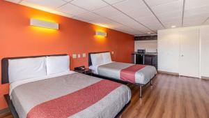 a hotel room with two beds and a kitchen at Hotel Elizabeth Near Newark Liberty International Airport New Jersey in Elizabeth