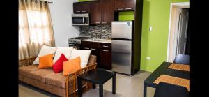 a living room with a couch and a kitchen at Eden Apartments in Basseterre +7 photos