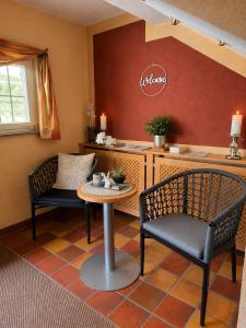 a kitchen with two chairs and a table at Hotel Altes Rathaus in Ostfildern