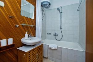 a bathroom with a sink and a tub and a shower at Apartment Plaza in Hvar +13 photos