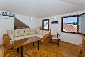 a living room with a couch and a table at Apartment Plaza in Hvar