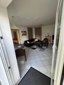 a living room with a couch and a table at Anjas Ferienwohnung Buchenrod in Flieden