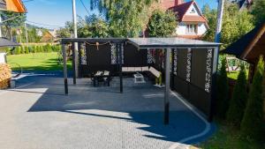 a play area with a black canopy in a yard at DW u Rafała i Joanny in Białka Tatrzańska