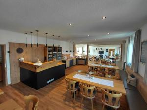 a kitchen and dining room with a table and chairs at Pension Karin in Breitengüßbach