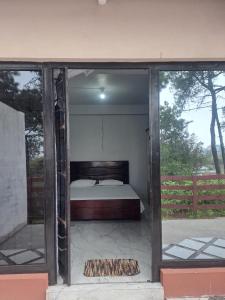 a bedroom with a bed inside of a building at Nashlem Homestay in Mawphlang