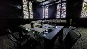 a table and chairs in a room with stained glass windows at DW u Rafała i Joanny in Białka Tatrzańska