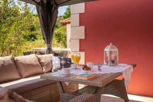 a table with food and drinks on a patio at Villa Liberty 2 in Cavtat