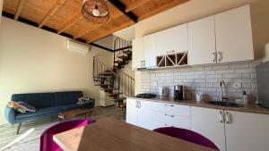 a kitchen with a couch and a table in a room at Chalet Kvariati in Kvariat'i