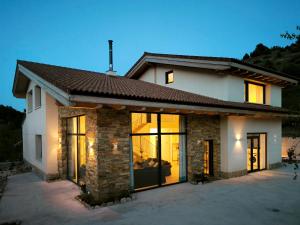 a house with large glass doors in front of it at Casa La Huertona de Castroserna in Castroserna de Arriba +27 photos