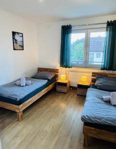 a room with two beds and a window at Ferienwohnung Adelsried 2 in Adelsried