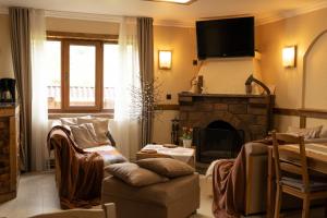 a living room with a couch and a fireplace at Krokus house in Verkhovyna