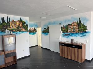a kitchen with a painting on the wall at Casa Kovacs in Herbolzheim