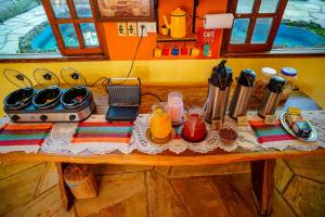 a table with food and utensils on it at Pousada Aconchego in Pirenópolis