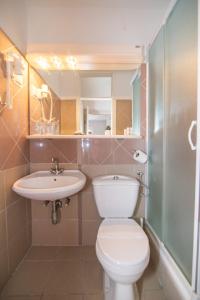 a bathroom with a toilet and a sink and a shower at Bed&Breakfast Saturn in Veli Lošinj +84 photos
