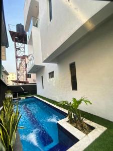 a swimming pool in the backyard of a house at Premium Height in Ikate