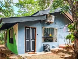 a small blue house with a tv on top of it at Sigiri Lake Paradise in Sigiriya