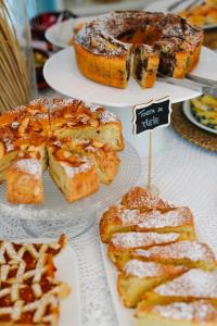 a table with three plates of bread and pastries at Il Borghetto Resort & Spa in Tropea