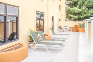a patio with chairs and tables on a building at Baymont by Wyndham Decatur IL North in Forsyth